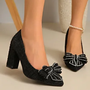 Elegant black tweed block heel pumps featuring a decorative pearl bow and pointed toe