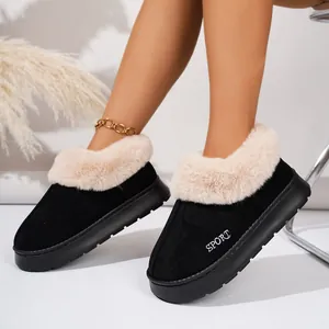 Close-up of black winter slippers with thick beige faux fur and anti-slip platform soles