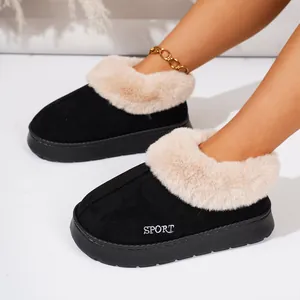 Detailed close-up of black winter platform slippers with cozy faux fur lining on feet