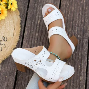 Stylish white chunky heel sandals with breathable laser-cut floral patterns for summer