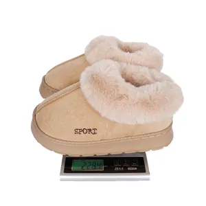 Soft khaki plush winter slippers for women being weighed on a digital scale, 228.4g.
