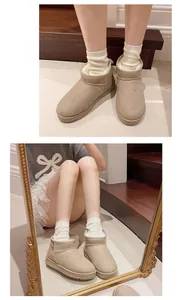 Warm beige mini snow boots with thick fur lining shown on a model in cozy home setting
