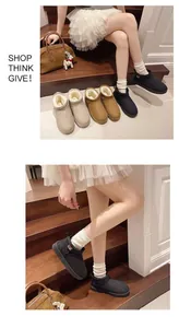 Close-up view of women's warm plush-lined short snow boots displayed on stairs
