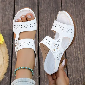 Elegant white wedge sandals featuring breathable laser-cut patterns and chunky heel