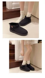 Classic black short snow boots with warm fur lining for winter shown on Asian model