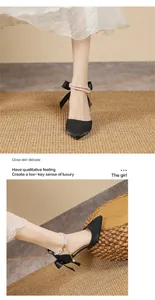 Detailed view of French black pointed-toe heels with pearl ankle strap and bow
