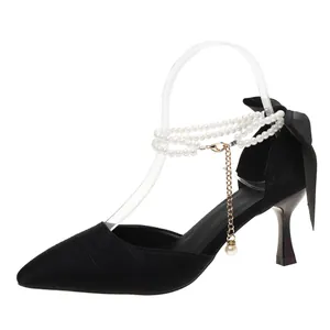 Elegant black pointed toe stiletto heels with triple pearl ankle strap and bow