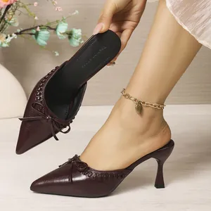 Elegant burgundy pointed-toe stiletto mules with bow detail and slender high heel.