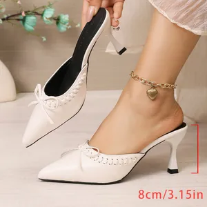 Elegant French style off-white pointed-toe mule heels featuring a bow detail and 8cm heel