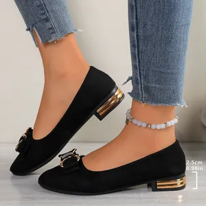 Detail of black pointed toe flats with rhinestone bow and 2.5cm gold heel