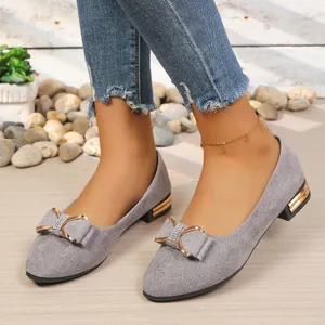 Detailed view of grey pointed-toe low heel pumps with elegant rhinestone bow accent