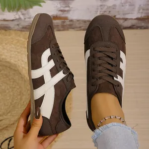 Top-down view of classic brown suede retro German army trainer sneakers on model