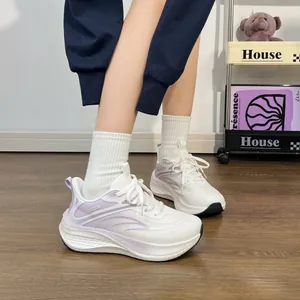Close-up view of stylish white and purple breathable running shoes for women