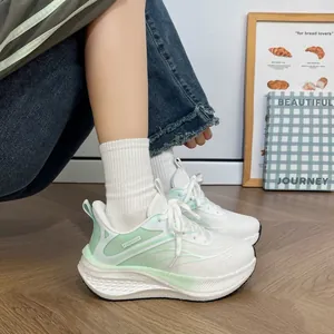 Detailed side view of women's chunky white and green breathable sneakers on model