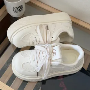 Top view of cream platform sneakers with unique cloud logo detail on tongue
