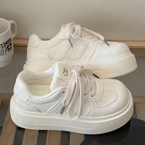 Detailed side view of cream platform sneakers with chunky soles and cute cloud logo design