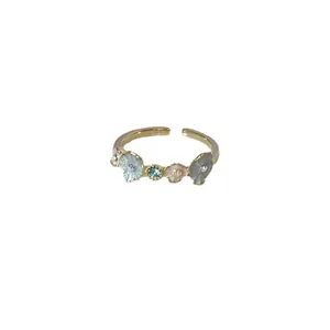 Elegant adjustable open ring featuring colorful floral design and central gemstone