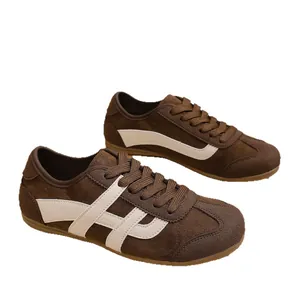 Classic brown retro suede trainers for women featuring cream stripes and rubber soles