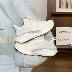 Detail view of white breathable mesh running sneakers for women with thick cushioned soles