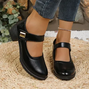 Detailed view of black chunky heel Mary Jane shoes with gold buckle and soft sole