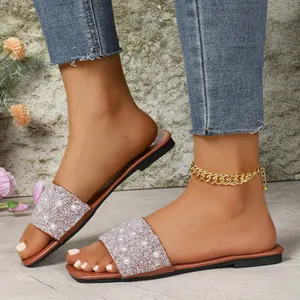 Chic flat sandals with rhinestone and pearl detailing on wide strap