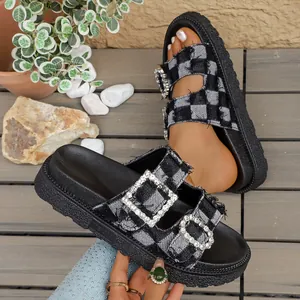 Detailed view of women's denim checkered platform slippers with rhinestone buckles