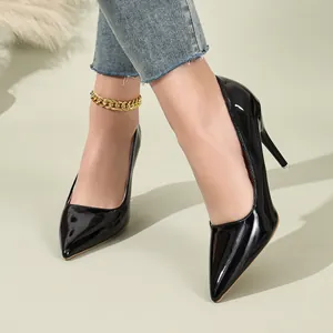 Detailed shot of elegant black patent leather pointed toe stiletto pumps worn by a model