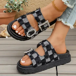 Close-up detail of stylish denim checkered sandals featuring sparkling rhinestone buckles