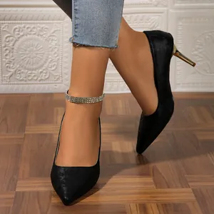 Detail of black pointed toe stiletto pumps with floral print and rhinestone ankle strap