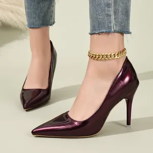 Detailed close-up showing the shiny dark purple patent leather of these elegant stiletto heels