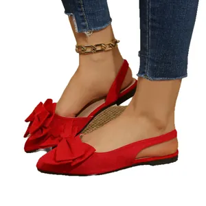Elegant red pointed-toe flat slingback sandals featuring a large decorative bow