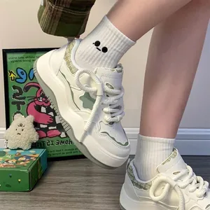 Close-up of women's white platform sneakers with star pattern and tweed trim details