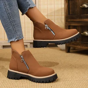 Stylish brown suede-like ankle boots featuring a side zipper and chunky black lug sole for winter