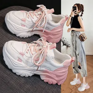 Detailed view of color-blocked chunky platform sneakers with white and pink accents