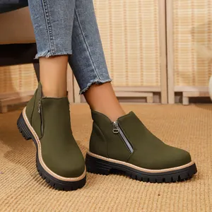 Detail of olive green round toe ankle boots with side zipper and chunky sole