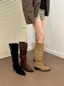 Three colors of women's slouchy pointed-toe high boots in black, brown and tan suede.