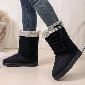 Detail of black Lolita cotton boots featuring white lace trim and bow decorations