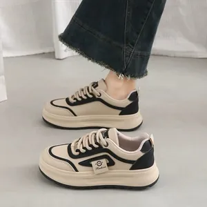 Detail view of chunky Korean-style beige sneakers with thick platform soles for casual wear