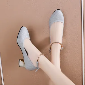 Detail of silver glitter chunky heel shoes with elegant ankle strap decoration