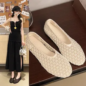 Detail view showing the breathable mesh texture and pointed toe of cream ballet flats