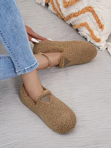 Detailansicht der braunen Fleece-Loafer mit runder Kappe und Marken-Patch.