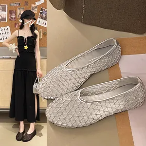 Close-up detail showing silver mesh flat shoes with breathable woven pattern texture