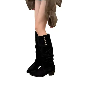Vintage black suede slouchy tall boots with pointed toe and decorative side metal buttons.