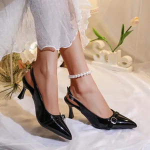 Elegant black patent leather stiletto slingback heels with stylish buckle design detail