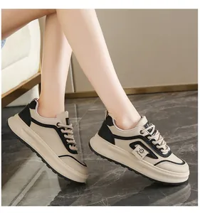 Detailed side view of women's beige platform sneakers with black accents and laces