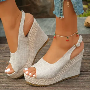 Detail view of stylish beige straw-textured peep-toe wedge sandals with buckle strap