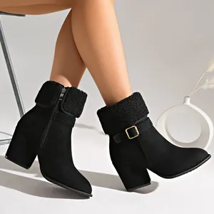 Detailed side view of black suede ankle boots featuring plush cuffs and chunky heels