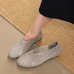 Close-up of silver breathable mesh flat shoes with elegant lattice pattern design