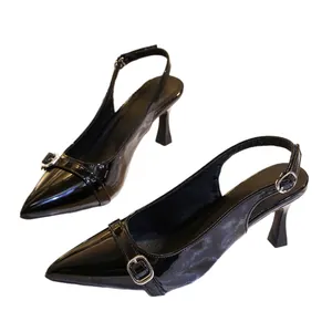 Elegant black patent leather slingback high heels with buckle detail and stiletto heel