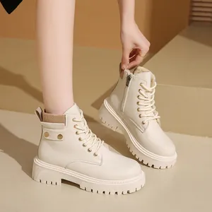 Detalle de botines con plataforma crema con forro polar y detalles dorados laterales.